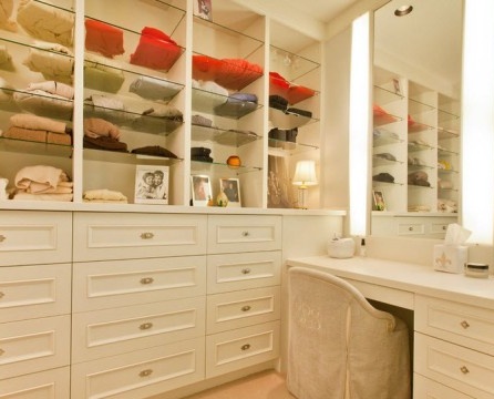 Open shelves for clothes in the dressing room with dressing table
