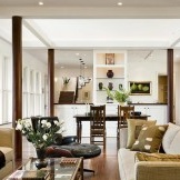 Two pairs of wooden columns in a living room interior