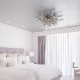 White bedroom with purple curtains