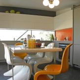 Orange chairs - emphasis on the interior of the kitchen