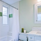 Fragment laid out in green mosaic to create a green bathroom interior