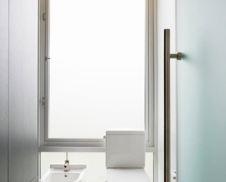 Glittering glossy white surfaces of walls and plumbing