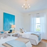 Painting in blue tones in a white bedroom