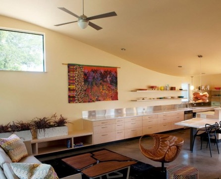 The combined space of the living room and kitchen is divided into functional areas