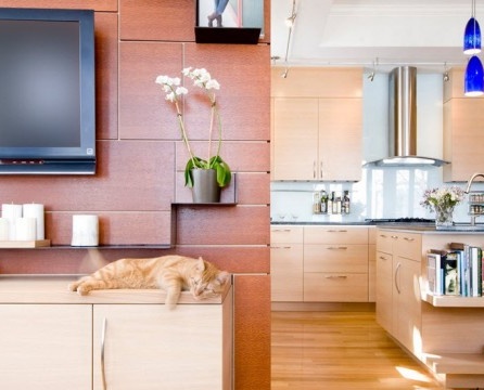 Televizors uz viesistabas sienas kopā ar virtuvi