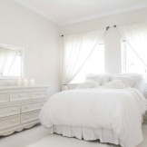 Snow-white bedroom with a chest of drawers