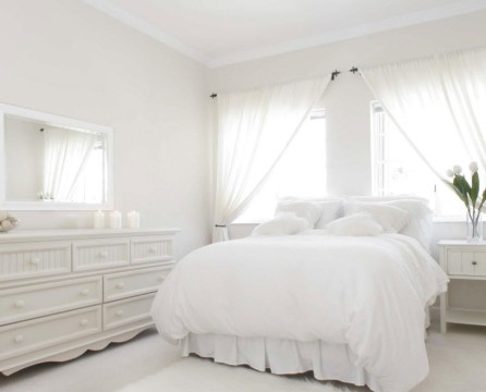 Snow-white bedroom with a chest of drawers