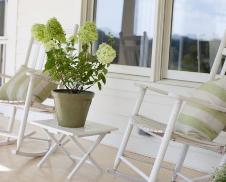 Cadeiras de balanço brancas na varanda