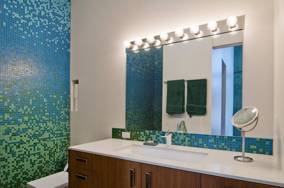 Blue-green mosaic on the wall in the bathroom