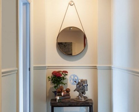 Round mirror on the rope in the hallway