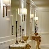 SSSSTwo mirrors with white sconces in the hallway