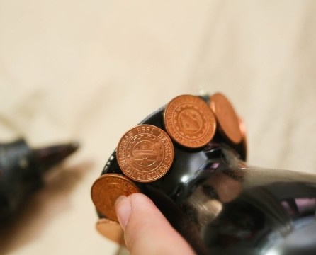 Coins glued to the neck of the basics