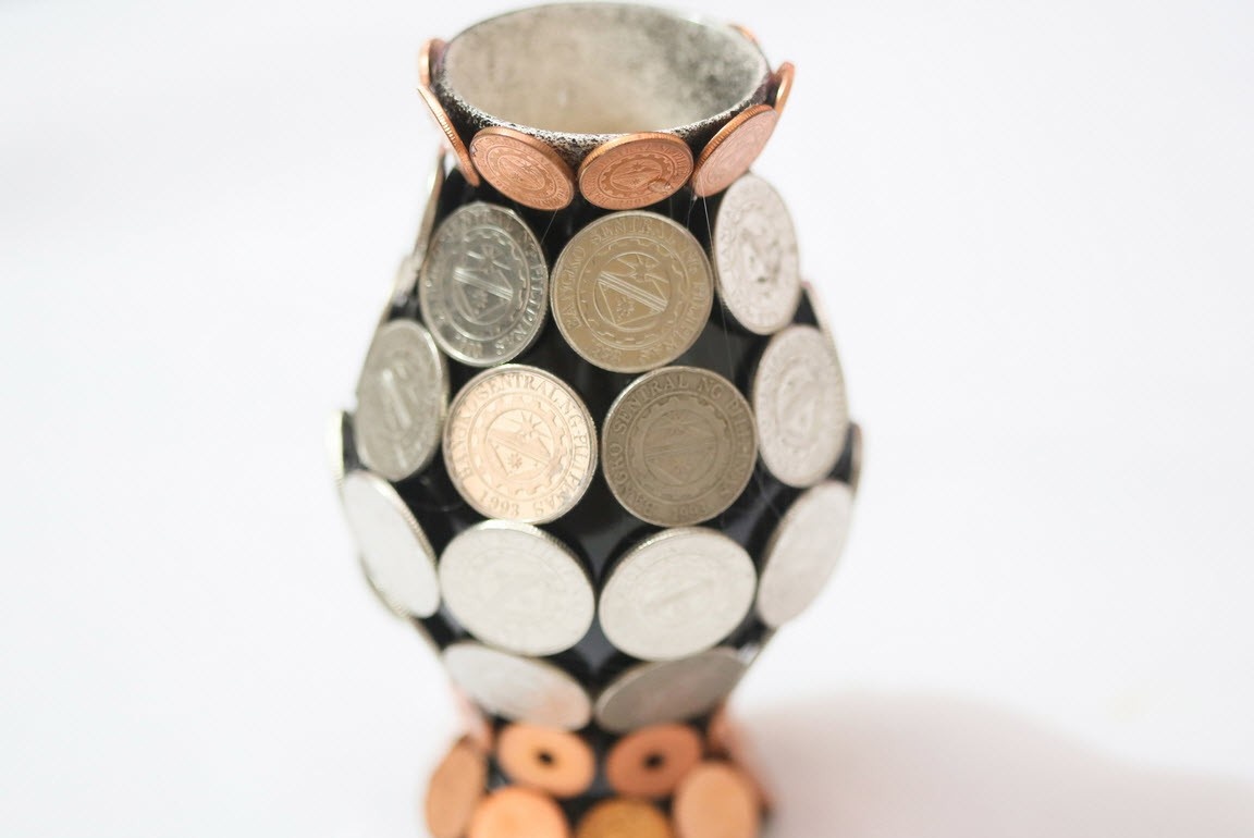 Vase glued with coins without a bouquet