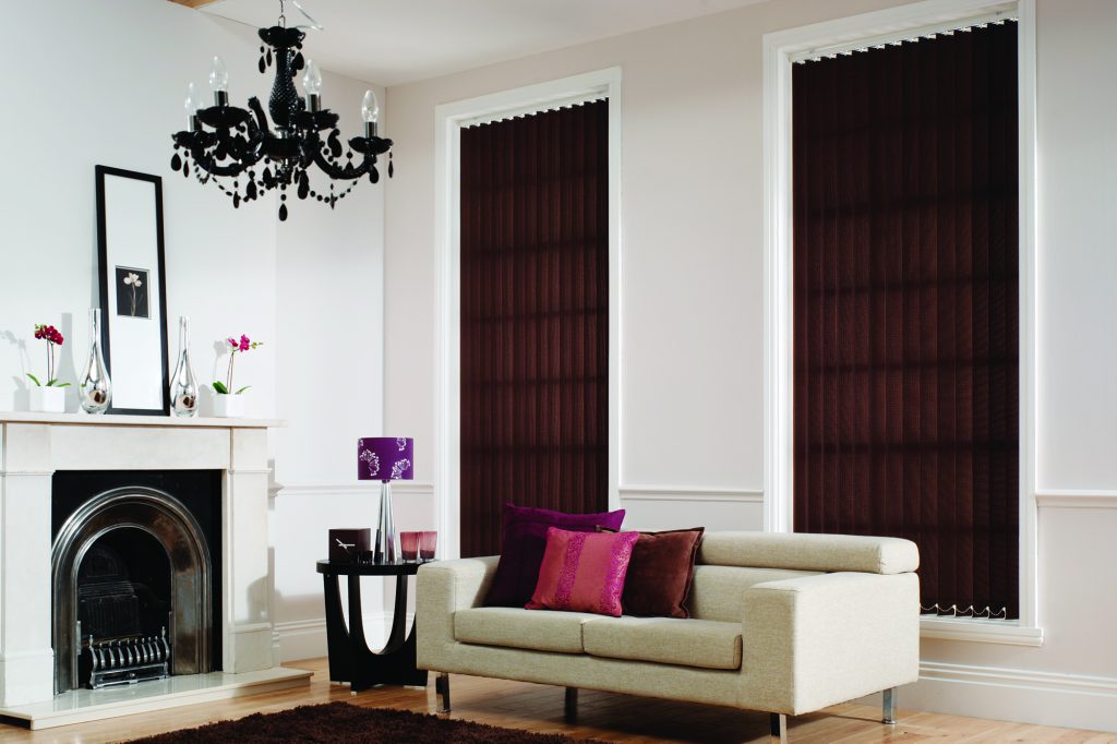 Vertical brown fabric blinds in a bright living room