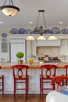 White, cream and red colors in a country style kitchen interior