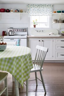 White wooden walls and brown floor in a country style kitchen