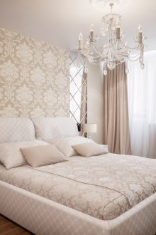 Beige and white bedroom with brown floor and mirror panels.