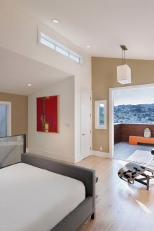 Beige and white bedroom with a red accent