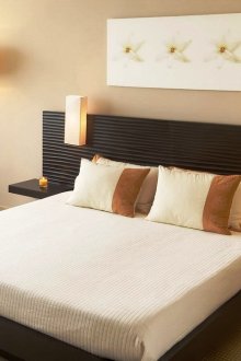 Beige, white and black colors in the bedroom interior.
