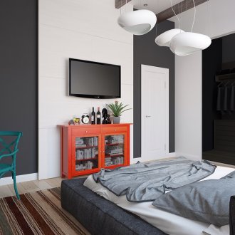 Orange, green and other accents in a black and white bedroom