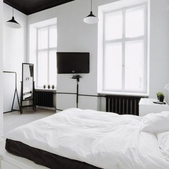 Black and white bedroom with black ceiling