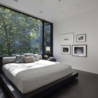 Black and white bedroom with large window.