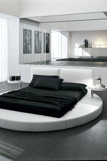 Round bed in a black and white hi-tech bedroom