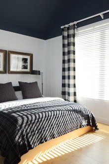 Black and white bedroom with beige floor