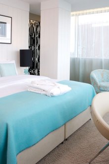 Beige bed and armchair in the bedroom