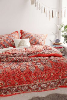 Red bedspread with print in the bedroom