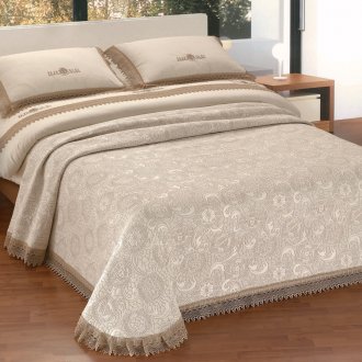 Beige bedspread with a pattern in the bedroom