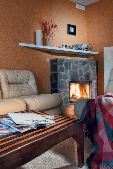 Checkered bedspread in the living room with fireplace
