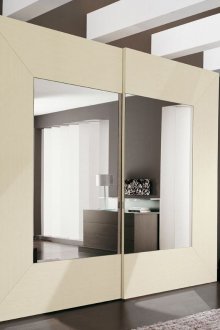 Beige-mirrored wardrobe in the interior