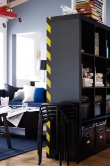 Black rack for zoning the apartment