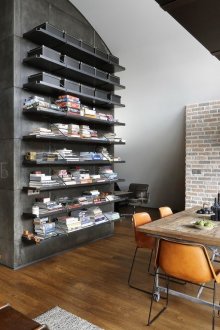 Black shelving in loft style interior