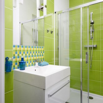 Light green and white tiles in a modern bathroom