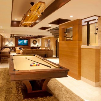 Basement party room with pool table in the basement.