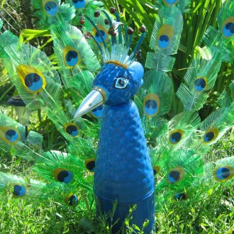 Peacock from plastic bottles in the country