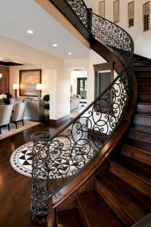 Swivel wooden staircase with wrought iron railing