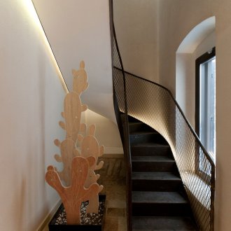 Black metal staircase with mesh railing