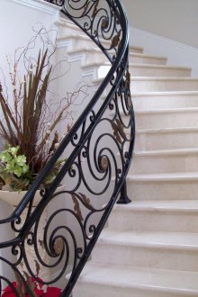 Classic stone staircase with wrought iron railings