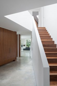 Wooden staircase with solid railing