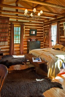 Spacious bedroom with a desk in Russian rustic style