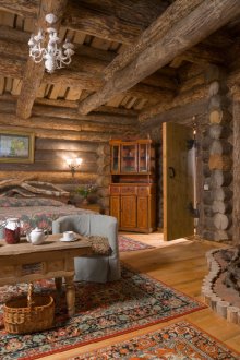 Bedroom with corner fireplace in a Russian rustic style