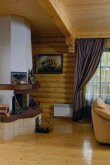 Large living room with fireplace in a Russian rustic style