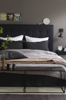 Black bed with soft headboard