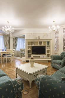 Provence style living room with dark green sofas