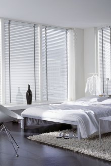 White blinds in a black and white bedroom