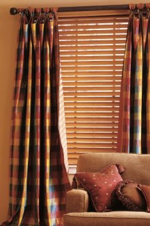 Cream blinds and plaid curtains in the living room