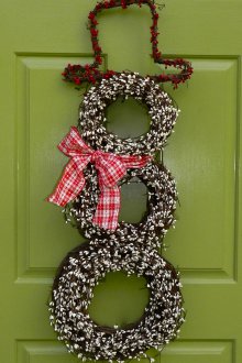 Snowman made of wreaths on the door